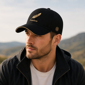 Male model wearing black embroidered baseball cap in an outdoor setting