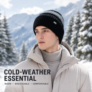 Black knit beanie worn outdoors in snowy winter setting, designed as a warm breathable cold-weather essential
