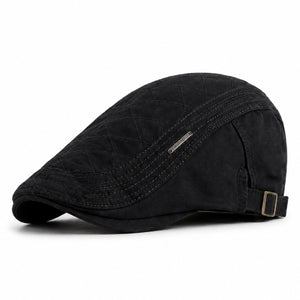 Black men's adjustable quilted flat cap with classic ivy shape and clean white background.