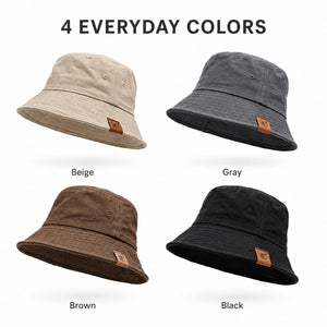 Four color cotton bucket hats in beige, gray, brown, and black on white background