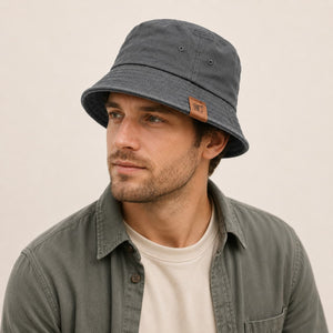 Model wearing gray cotton bucket hat on clean light background