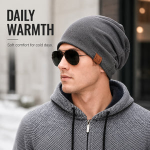 Gray slouchy winter beanie worn with a casual layered outfit