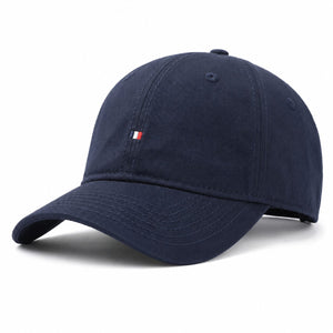 Navy cotton sun protection baseball cap with curved brim, soft crown, and adjustable strap.