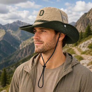 Male model wearing an olive green outdoor hiking bucket hat with wide brim, breathable mesh panel and adjustable chin cord on a clean white background.