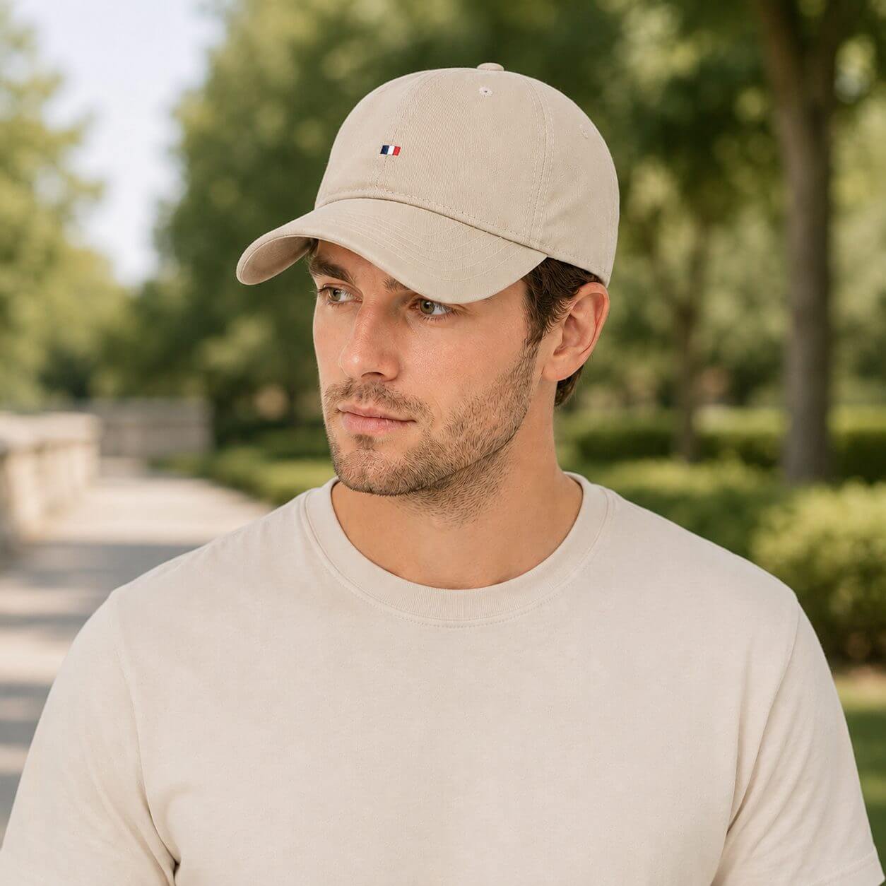 Beige cotton sun protection baseball cap worn by a male model on a clean white background.
