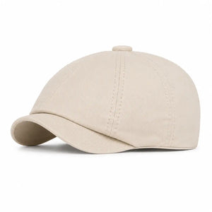 Beige vintage newsboy cap with curved brim and lightweight cotton fabric