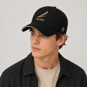 Black embroidered baseball cap with gold leaf design and curved brim