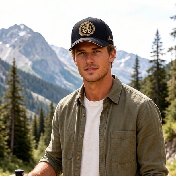 Black embroidered cotton baseball cap with gold front emblem, curved brim, and adjustable back strap