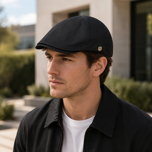 Male model wearing a black vintage British flat cap with smart casual outdoor styling.