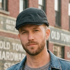 Black vintage cotton flat cap with adjustable buckle and classic old-money style