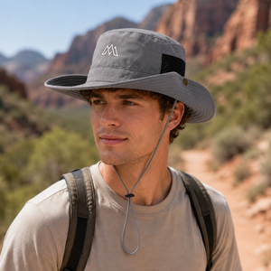 Gray outdoor sun protection bucket hat with breathable mesh panel, adjustable chin cord, snap side brim, and lightweight polyester construction