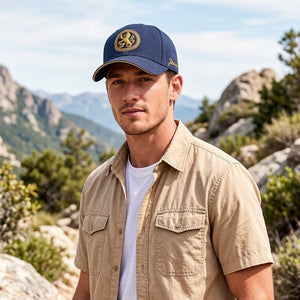 Navy embroidered cotton baseball cap with gold front emblem, structured crown, and outdoor casual style