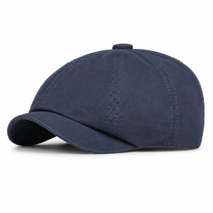 Navy blue vintage newsboy cap with curved brim and classic casual style