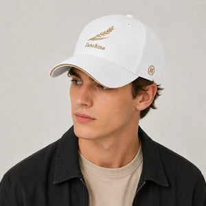 White embroidered baseball cap with gold leaf design and curved brim